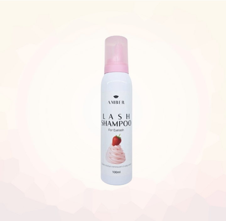 Lash shampoo bottle with pink cap on a light pink background