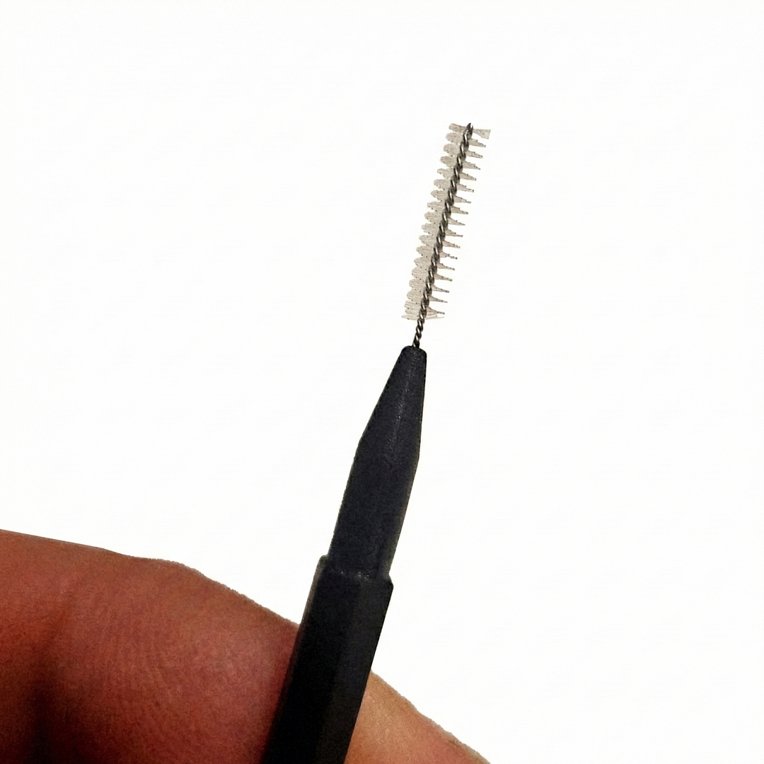 Micro spoolie applicator with cap used for brow styling and lash grooming