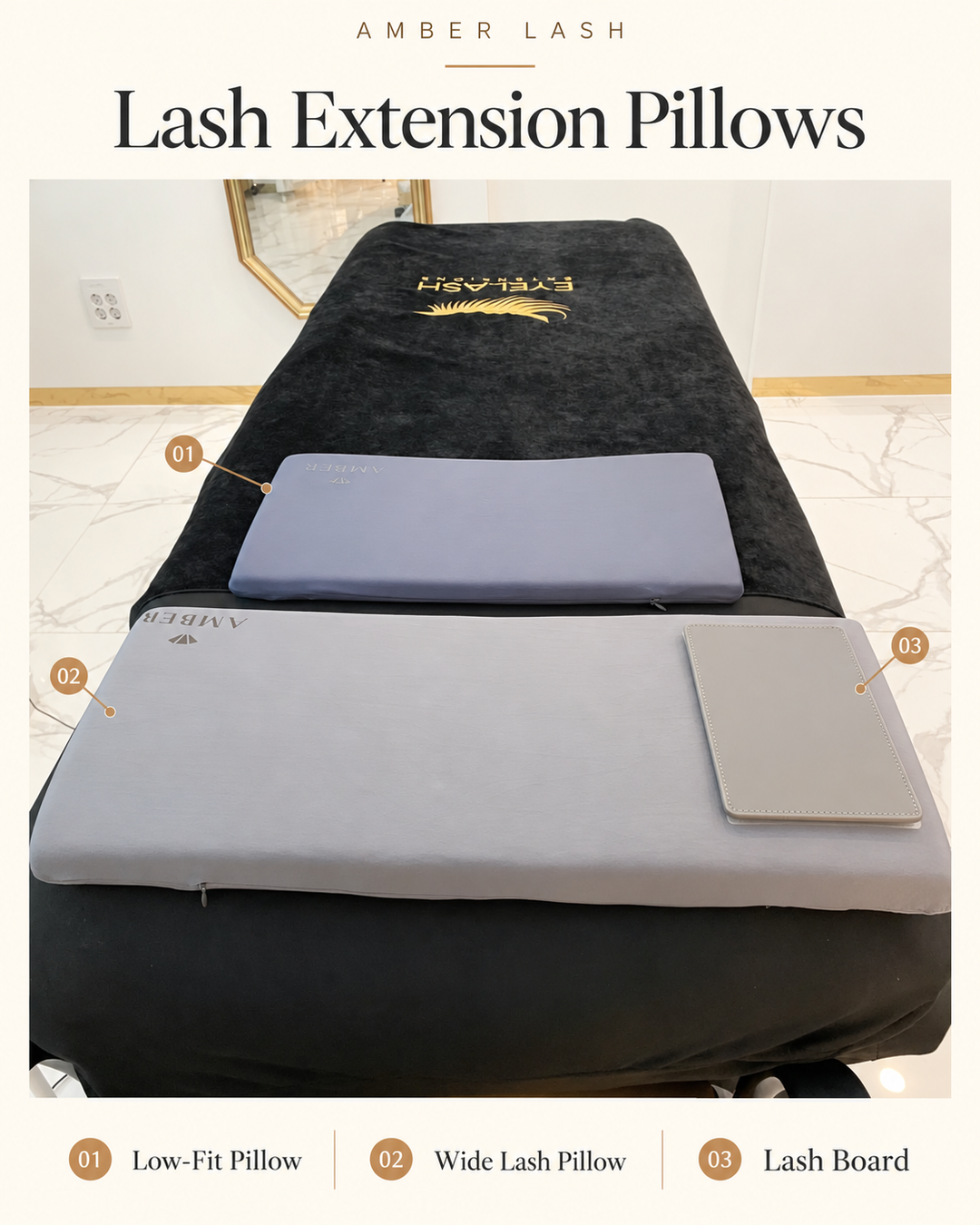 Amber Lash wide gray pillow and lavender Low-Fit Pillow with a lash board displayed on a black eyelash extension treatment bed.