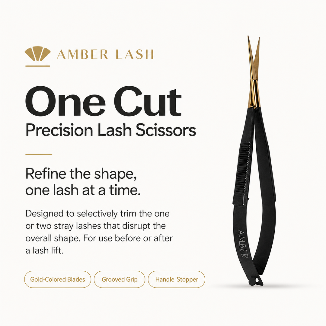Amber Lash One Cut Precision Lash Scissors standing upright on an ivory background with soft shadows.
