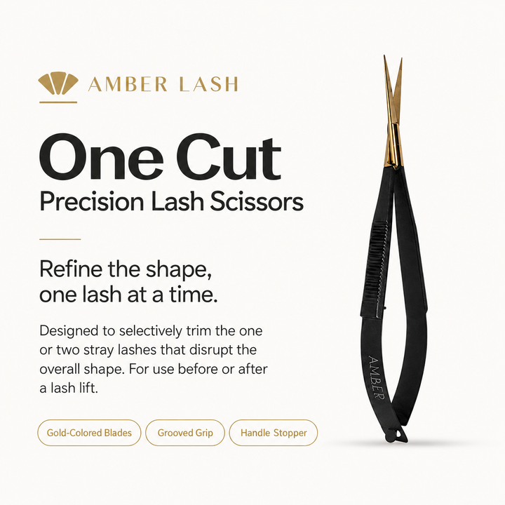 Amber Lash One Cut Precision Lash Scissors standing upright on an ivory background with soft shadows.