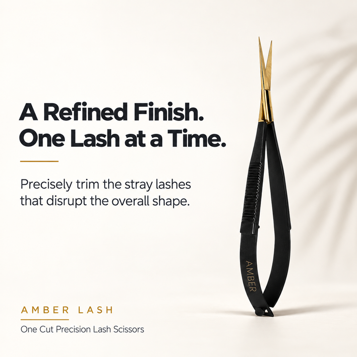 Amber Lash One Cut Precision Lash Scissors with slim gold-colored blades and a black handle.