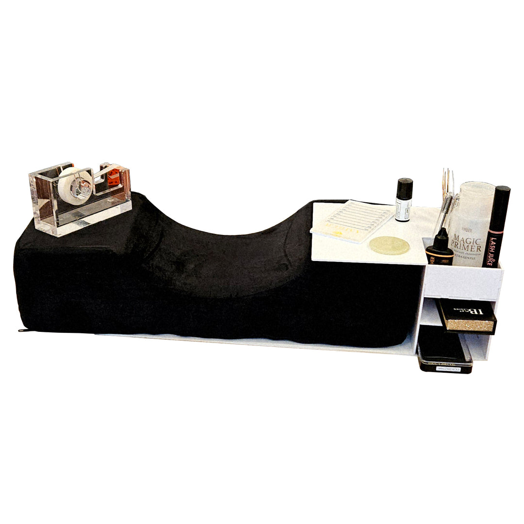 White acrylic lash pillow stand organizer on a lash pillow, holding lash primer, lash juice, tweezers, and supplies, side view