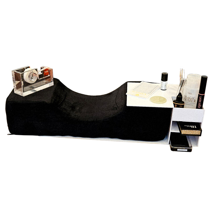 White acrylic lash pillow stand organizer on a lash pillow, holding lash primer, lash juice, tweezers, and supplies, side view