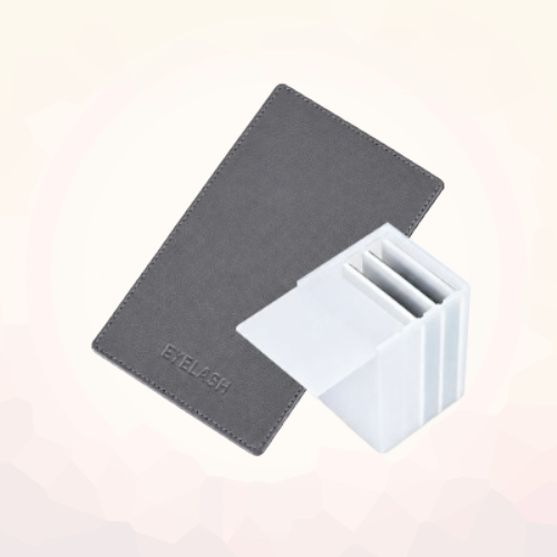 Charcoal magnetic lash holder board and white mini storage box shown together on a light background