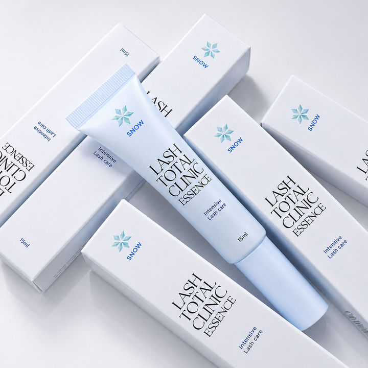 Snow Lash Total Clinic Essence 15 mL tube displayed with product boxes